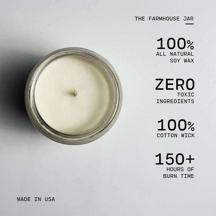 Candle in a glass jar with text highlighting its features on a gray background