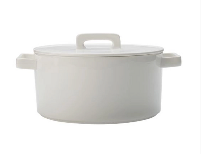 A round white porcelain casserole dish with lid and two handles.