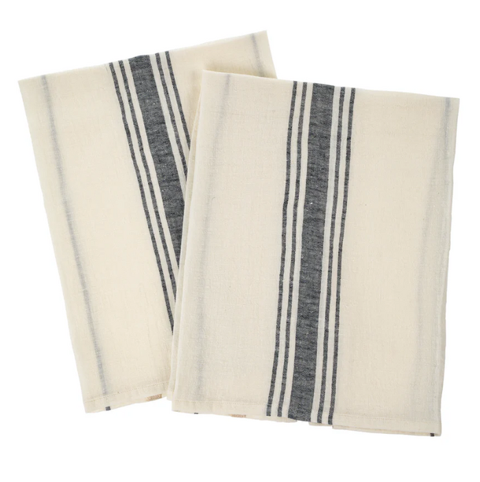 Two folded striped linen tea towels, primarily white with gray stripes, on a white background.