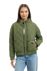 Woman wearing a green quilted jacket on a white background