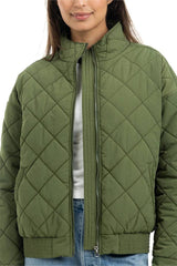 Person wearing a green quilted jacket on a white background